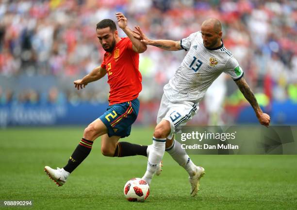 Dani Carvajal of Spain and Fedor Kudriashov of Russia battle for the ball during the 2018 FIFA World Cup Russia Round of 16 match between Spain and...