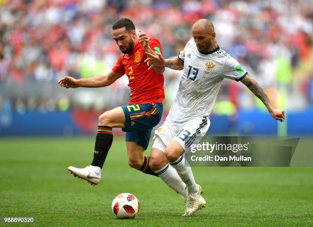 Dani Carvajal of Spain and Fedor Kudriashov of Russia battle for the ball during the 2018 FIFA World Cup Russia Round of 16 match between Spain and...
