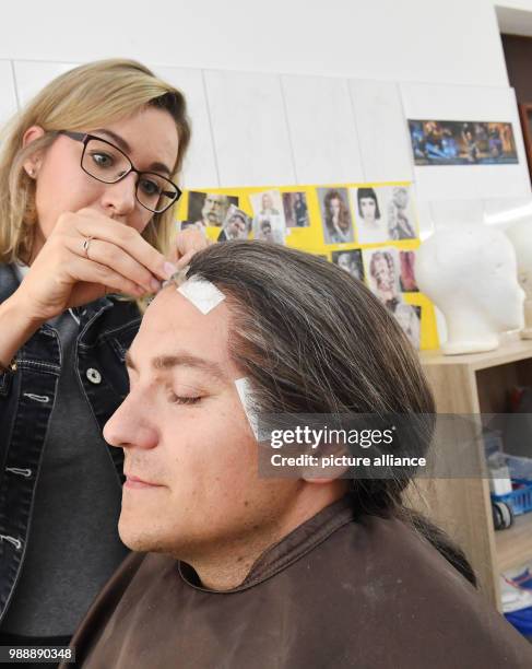 June 2018, Germany, Zinnowitz: Western Pomerania state secretary Patrick Dahlemann is fitted with a wig for a guest role in the make-up room of...