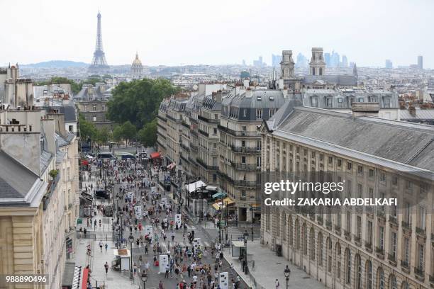 General view shows people walking on the rue Soufflot following the burial ceremony of former French politician and Holocaust survivor Simone Veil...