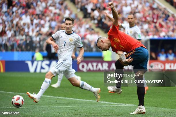 Spain's forward Iago Aspas kicks the ball past Russia's midfielder Daler Kuzyaev during the Russia 2018 World Cup round of 16 football match between...