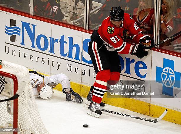 Marian Hossa of the Chicago Blackhawks tries for the puck after colliding with Dan Hamhuis of the Nashville Predators in Game Five of the Western...