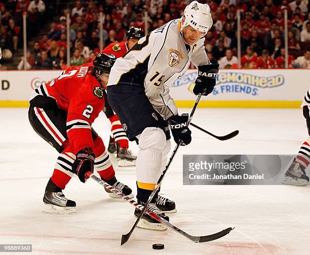 Jason Arnott of the Nashville Predators controls the puck under pressure from Duncan Keith of the Chicago Blackhawks in Game Five of the Western...