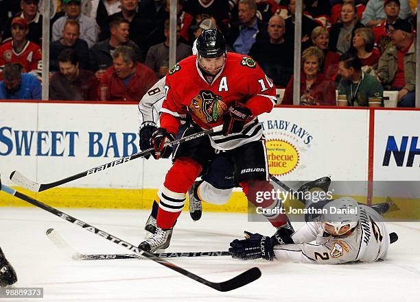 Dan Hamhuis of the Nashville Predators falls to the ice to knock the puck away from Patrick Sharp of the Chicago Blackhawks in Game Five of the...