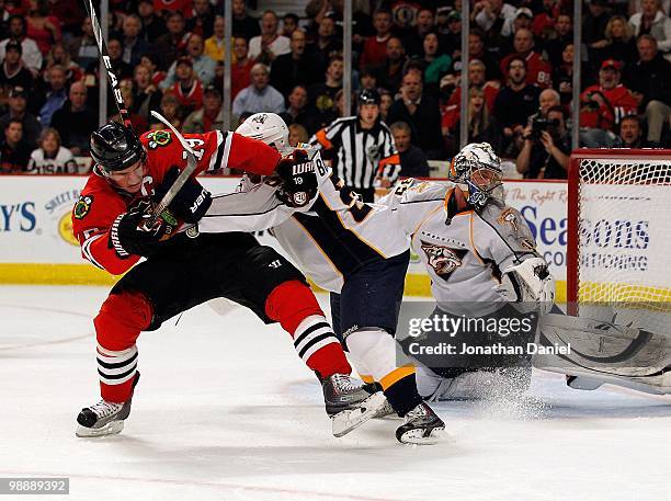 Jonathan Toews of the Chicago Blackhawks battles with Francis Bouillon of the Nashville Predators in front of Pekka Rinne in Game Five of the Western...