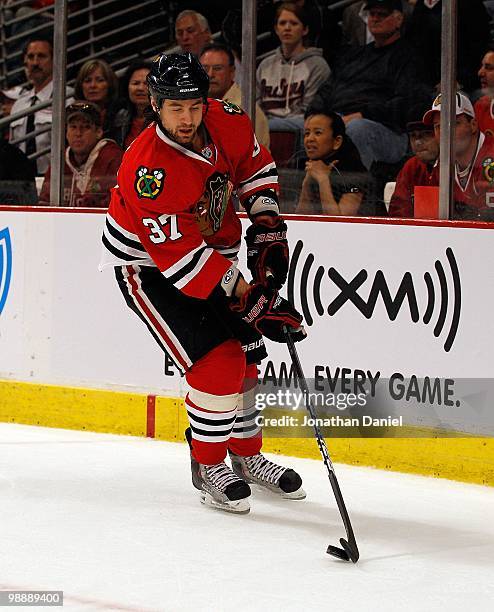 Adam Burish of the Chicago Blackhawks controls the puck against the Nashville Predators in Game Five of the Western Conference Quarterfinals during...