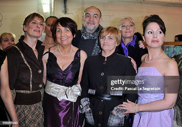 French designer Christian Lacroix, poses with models and designers of the association "Tissons la Solidarite" at Docks en Seine on May 6, 2010 in...