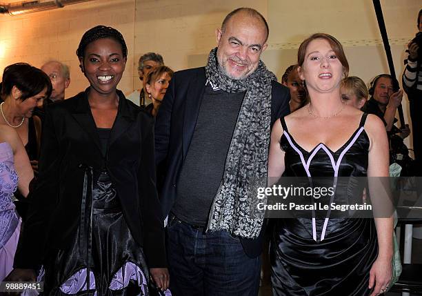 French designer Christian Lacroix, poses with models and designers of the association "Tissons la Solidarite" at Docks en Seine on May 6, 2010 in...