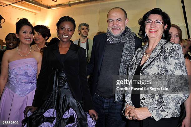 French designer Christian Lacroix, poses with models and designers of the association "Tissons la Solidarite" at Docks en Seine on May 6, 2010 in...