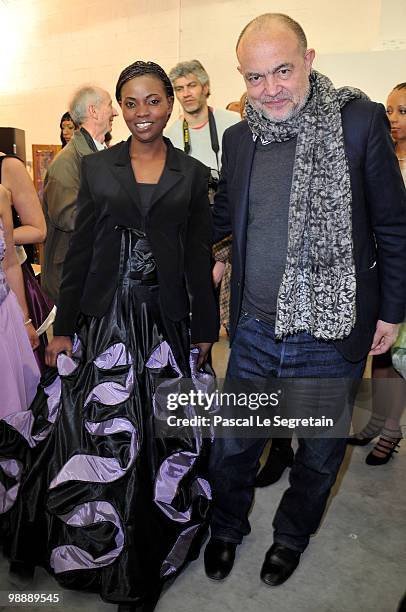 French designer Christian Lacroix, poses with a model of the association "Tissons la Solidarite" at Docks en Seine on May 6, 2010 in Paris, France....