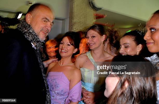 French designer Christian Lacroix, poses backstage with models and designers of the association "Tissons la Solidarite" at Docks en Seine on May 6,...