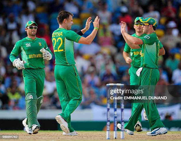 South African bowler Johan Botha celebrates with teammates after the dismissal of New Zealand batsman Martin Guptill during the ICC World Twenty20...