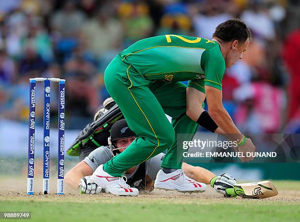 New Zealand batsman Martin Guptill dives to safety as South African bowler Johan Botha attempts to run him out during The ICC World Twenty20 Super...