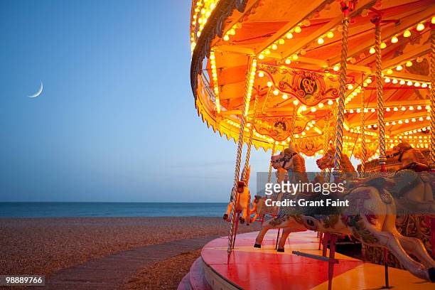 partial view of carousel on beach area - moon shore stock pictures, royalty-free photos & images