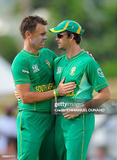 South African bowler Johan Botha celebrates with teammate Albie Morkel after the dismissal of New Zealand batsman Martin Guptill during the ICC World...