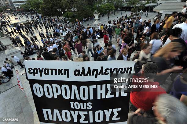 Placard reading 'Tax the rich' is pictured as demonstrators gather on the Athen's main Syntagma square during a protest in front of the Greek...