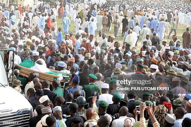 The casket containing the body of late Nigerian President Umaru Yar'Adua is carried to the cemetery, in Katsina, on May 6, 2010. Thousands of...