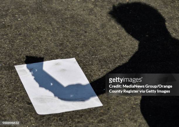 Science teacher Bev Berekian holds a 3D printed solar eclipse shadow viewer in the shape if California at Lexington Junior High School in Cypress,...