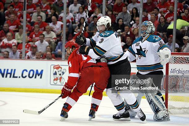 Douglas Murray and Evgeni Nabokov of the San Jose Sharks defend against Todd Bertuzzi of the Detroit Red Wings in Game Three of the Western...