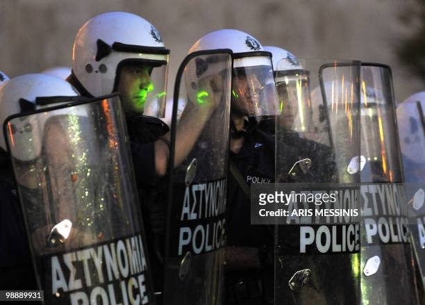 Laser beam is pointed at Greek riot policemen during an anti-austerity demonstration in the center of Athens on May 6, 2010. Riot police charged...