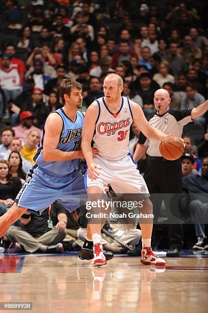 Chris Kaman of the Los Angeles Clippers posts up Mehmet Okur of the Utah Jazz during the game on March 1, 2010 at Staples Center in Los Angeles,...