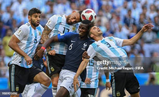 Nicolas Otamendi of Argentina competes for a header with Paul Pogba of France and Nicolas Tagliafico of Argentina during the 2018 FIFA World Cup...