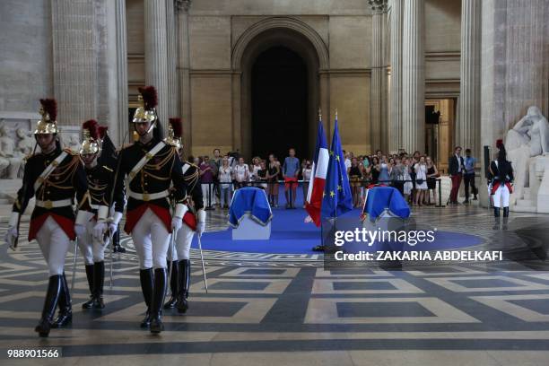 People pay their respects by the coffins of former French politician and Holocaust survivor Simone Veil and her husband Antoine Veil surrounded by...