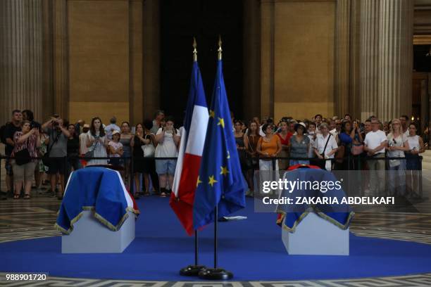 People pay their respects by the coffins of former French politician and Holocaust survivor Simone Veil and her husband Antoine Veil surrounded by...