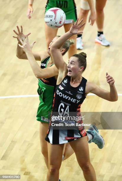Alice Teague-Neeld of the Magpies and Courtney Bruce of the Fever compete for the ball during the round nine Super Netball match between the Magpies...