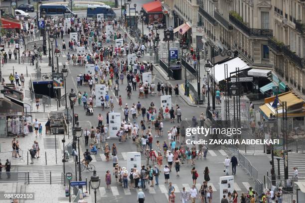 General view shows people walking on the rue Soufflot following the burial ceremony of former French politician and Holocaust survivor Simone Veil...