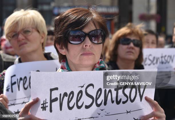 People hold placards with an appeal to free Ukrainian film director Oleg Sentsov during a rally in Kiev on July 1 to demand the release Oleg Sentsov...