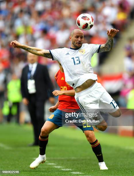 Marco Asensio of Spain puts pressure on Fedor Kudriashov of Russia during the 2018 FIFA World Cup Russia Round of 16 match between Spain and Russia...