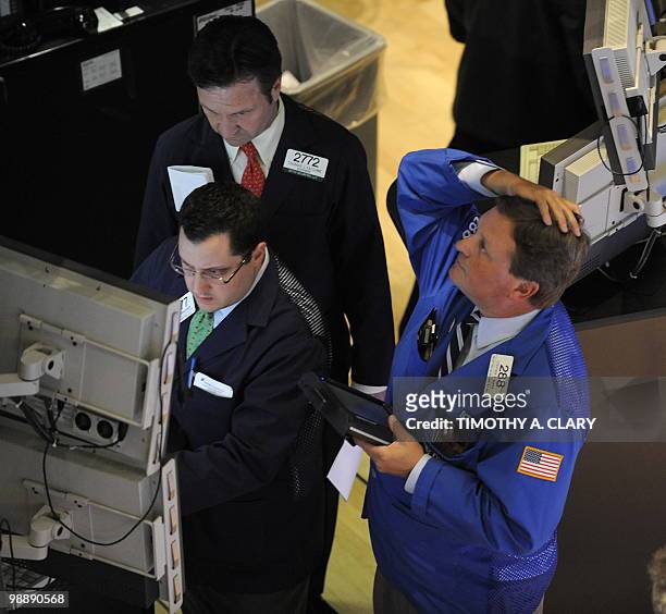 Trader on the floor of the New York Stock Exchange looks at stocks during the final minutes of trading May 6, 2010 as the Dow lost almost 1,000...