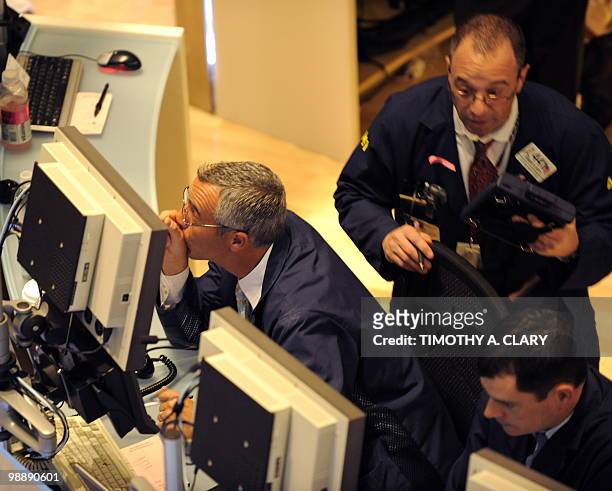 Trader on the floor of the New York Stock Exchange looks at stocks during the final minutes of trading May 6, 2010 as the Dow lost almost 1,000...