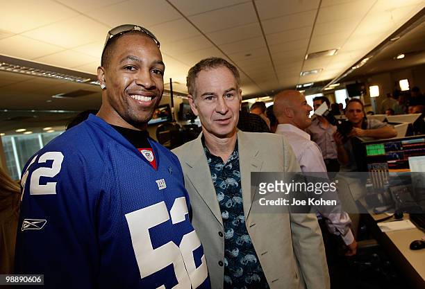 Michael Boley and John McEnroe attends the 8th annual Commissions for Charity Day at BTIG on May 6, 2010 in New York City.