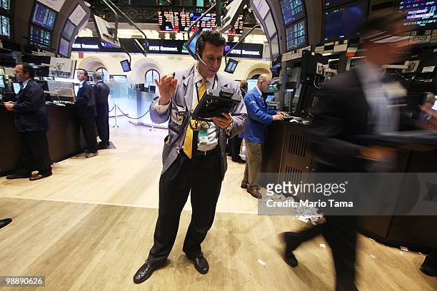 Traders work on the floor of the New York Stock Exchange before the closing bell May 6, 2010 in New York City. The Dow plunged almost 1000 points...