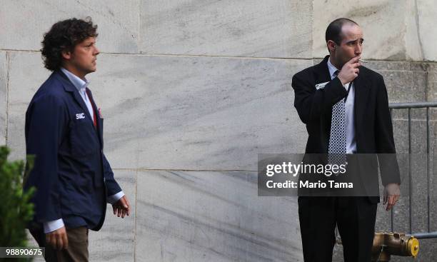 Traders stand outside the New York Stock Exchange before the closing bell May 6, 2010 in New York City. The Dow plunged almost 1000 points before...