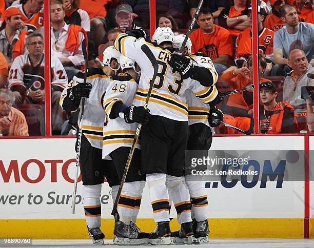 Patrice Bergeron, Matt Hunwick, Zdeno Chara and Blake Wheeler of the Boston Bruins all celebrate a goal against the Philadelphia Flyers in Game Three...