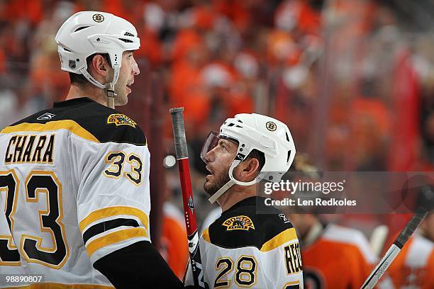 Zdeno Chara and Mark Recchi of the Boston Bruins talk during a stoppage in play against the Philadelphia Flyers in Game Three of the Eastern...