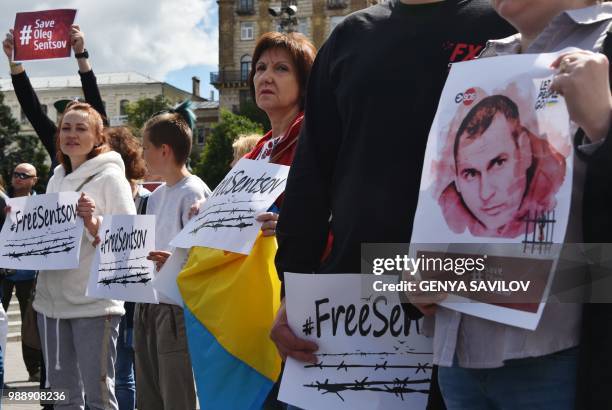 People hold placards with an appeal to free Ukrainian film director Oleg Sentsov during a rally in Kiev on July 1 to demand the release Oleg Sentsov...