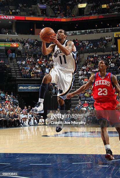 Mike Conley of the Memphis Grizzlies takes the ball to the basket against Louis Williams of the Philadelphia 76ers during the game at the FedExForum...