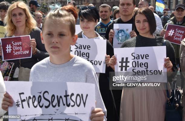 People hold placards with an appeal to free Ukrainian film director Oleg Sentsov during a rally in Kiev on July 1 to demand the release Oleg Sentsov...