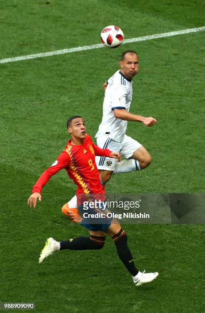 Rodrigo of Spain controls the ball under pressure from Sergey Ignashevich of Russia during the 2018 FIFA World Cup Russia Round of 16 match between...
