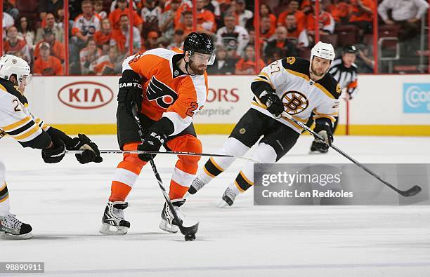 Ville Leino of the Philadelphia Flyers skates with the puck past Steve Begin of the Boston Bruins in Game Three of the Eastern Conference Semifinals...