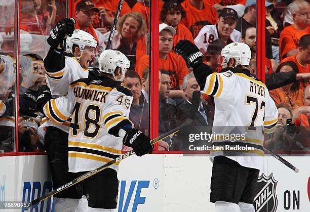 Blake Wheeler of the Boston Bruins celebrates his first period goal with teammates Matt Hunwick and Michael Ryder against the Philadelphia Flyers in...