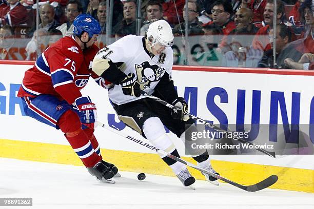 Evgeni Malkin of the Pittsburgh Penguins and Hal Gill of the Montreal Canadiens chase the puck into the corner in Game Three of the Eastern...