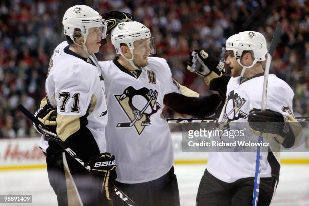 Evgeni Malkin of the Pittsburgh Penguins celebrates his third period goal with team mates in Game Three of the Eastern Conference Semifinals against...