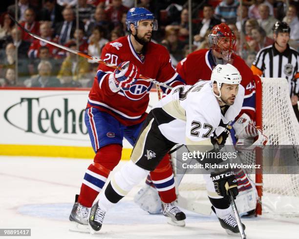 Ryan O'Byrne of the Montreal Canadiens defends against Craig Adams of the Pittsburgh Penguins in Game Three of the Eastern Conference Semifinals...