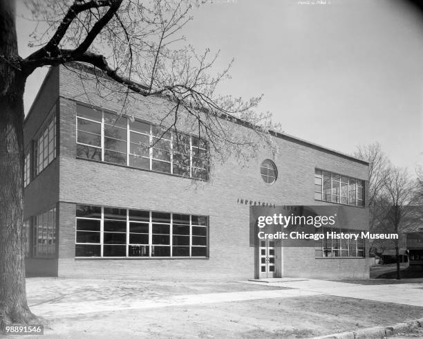 Exterior view of the Industrial Arts School, a two-story brick building with ribbon windows, showing the entrance. Located at 104 Woodlawn Street in...