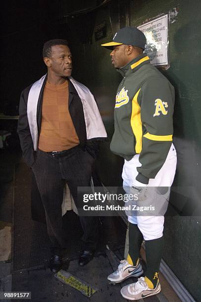 Oakland Athletics Rajai Davis in dugout with former MLB player and Hall of Famer Rickey Henderson before game vs New York Yankees. Henderson was A's...